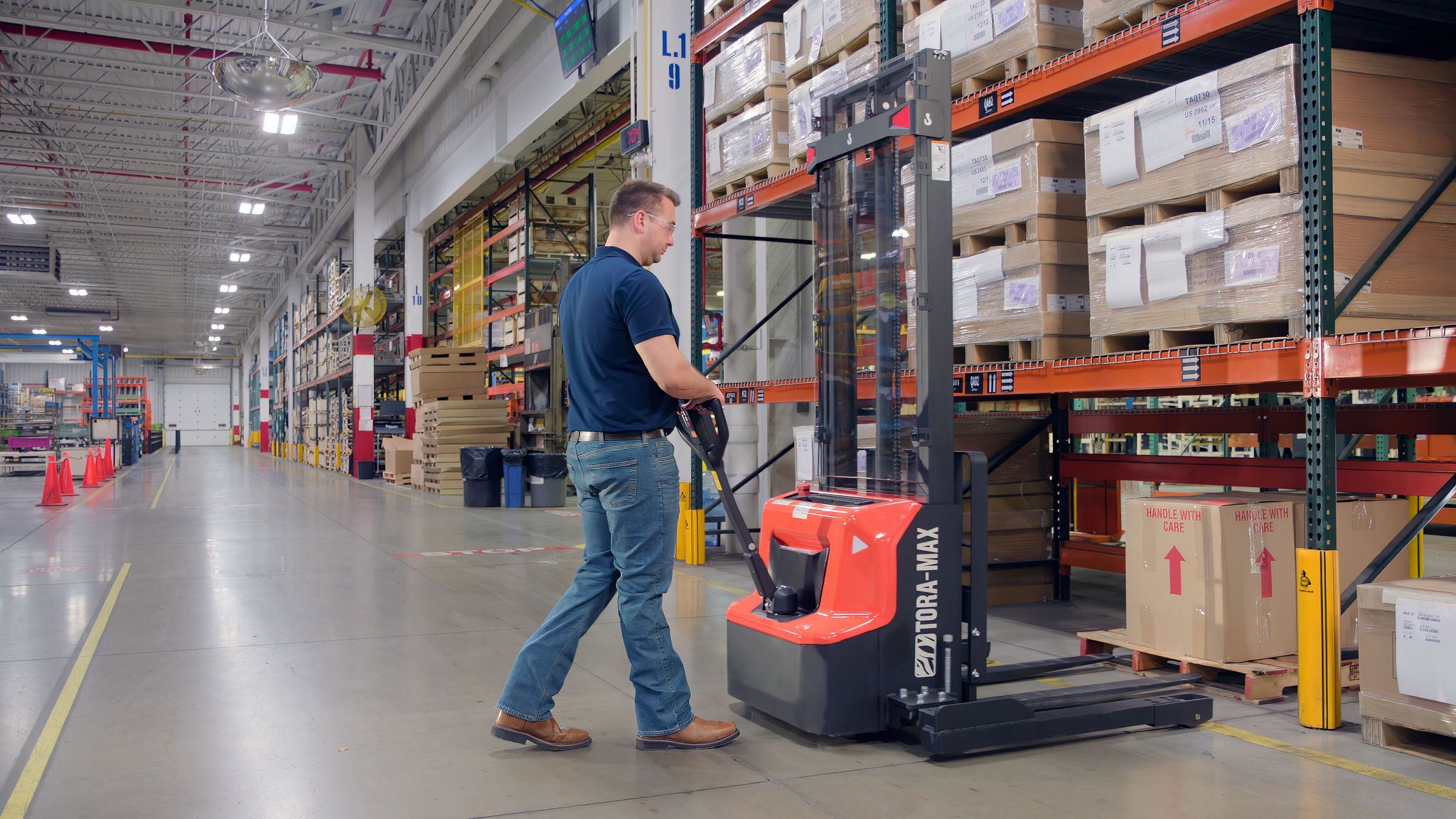 tora-max walkie stacker being used by male about to pick up pallet